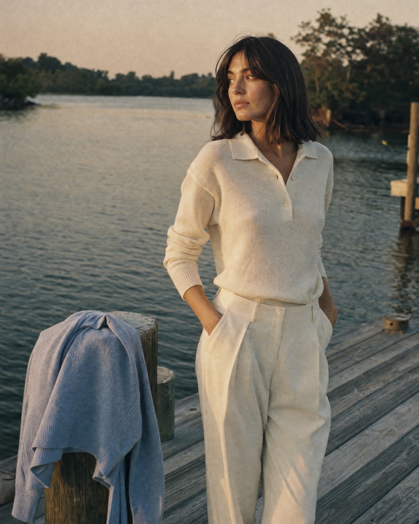 Azurelle editorial hero image, vertical, woman in cream knit on a waterfront dock