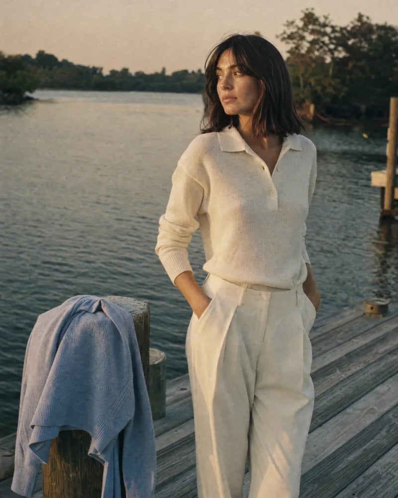 Azurelle editorial hero image, vertical, woman in cream knit on a waterfront dock